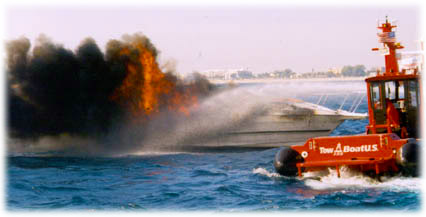 TowBoatU.S. firefighting vessel on fire during salvage.