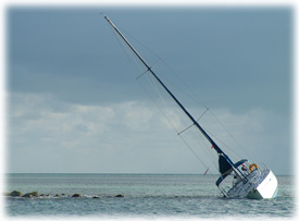 Sailboat sinking during boat salvage recovery.